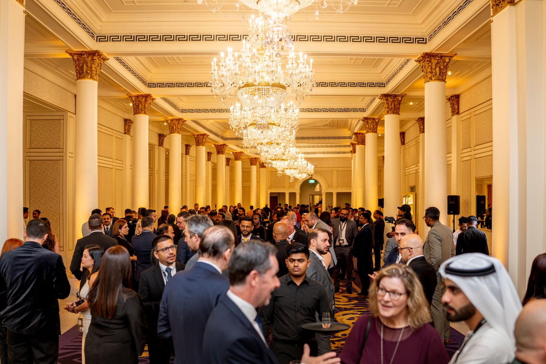 Guests mingling at the reception in the ballroom foyer