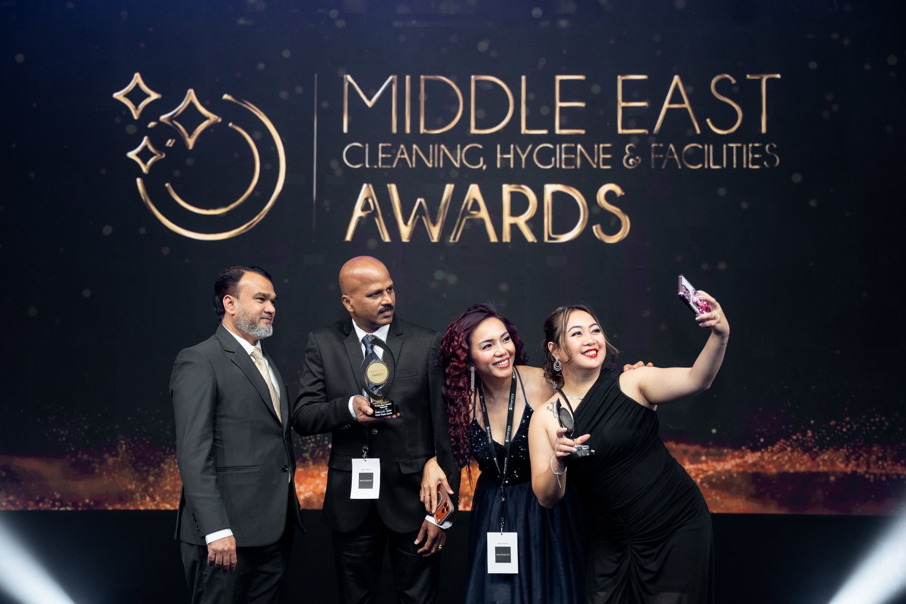 Winners celebrating with a selfie on stage