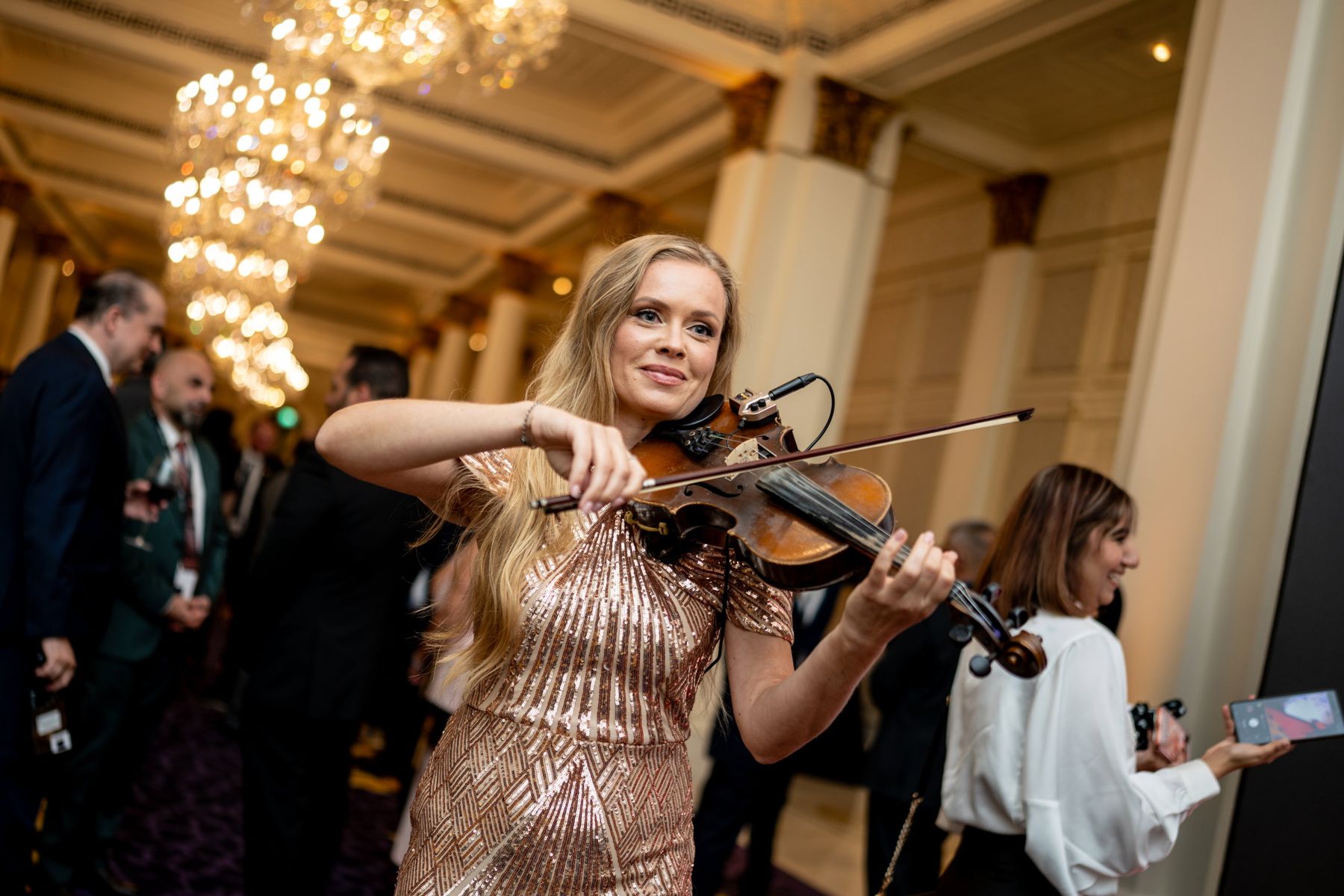 A violinist performing for guests at the reception